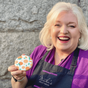 A woman holding a cookie in her hand.